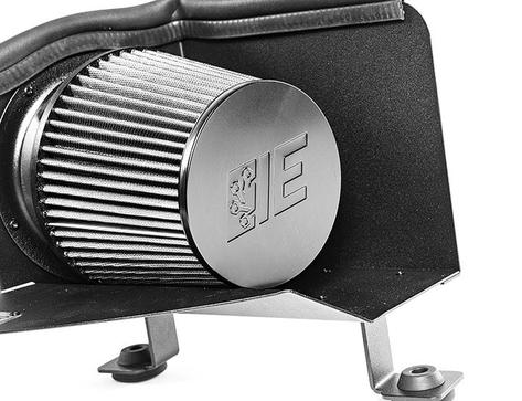 Close-up of a silver air filter with a ridged design, mounted on a black metal base. Features an embossed "IE" logo.